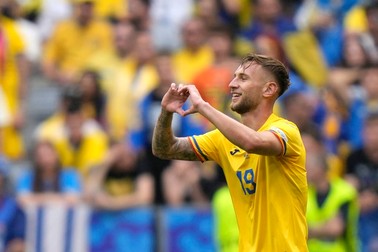 Romania's Denis Dragus celebrates after scoring his side's third goal during a Group E match between Romania and Ukraine at the Euro 2024 soccer tournament in Munich, Germany, Monday, June 17, 2024.,Image: 882361913, License: Rights-managed, Restrictions: This content is intended for editorial use only. For other uses, additional clearances may be required., Model Release: no, Pictured: Denis Dragus