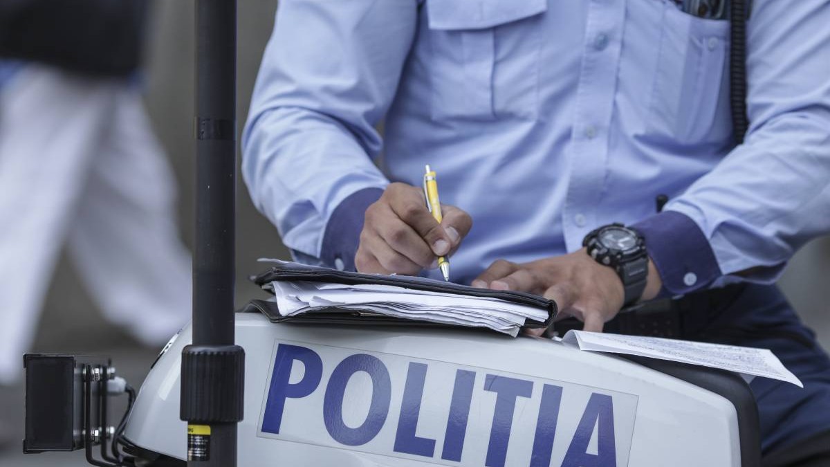 politist in timp ce scrie o amenda rutiera