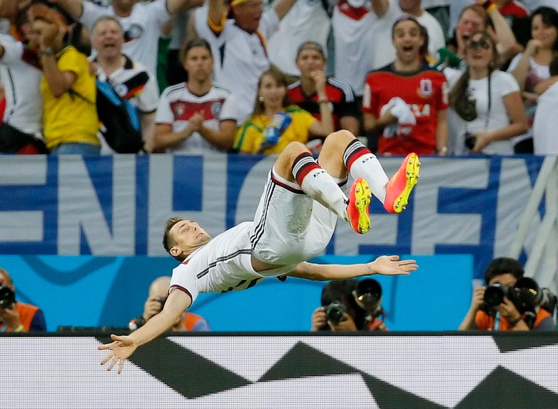 epaselect epa04271867 Miroslav Klose of Germany celebrates his 2-2 goal during the FIFA World Cup 2014 group G preliminary round match between Germany and Ghana at the Estadio Castelao in Fortaleza, Brazil, 21 June 2014. (RESTRICTIONS APPLY: Editorial Use Only, not used in association with any commercial entity - Images must not be used in any form of alert service or push service of any kind including via mobile alert services, downloads to mobile devices or MMS messaging - Images must appear as still images and must not emulate match action video footage - No alteration is made to, and no text or image is superimposed over, any published image which: (a) intentionally obscures or removes a sponsor identification image; or (b) adds or overlays the commercial identification of any third party which is not officially associated with the FIFA World Cup) EPA/SERGEY DOLZHENKO EDITORIAL USE ONLY