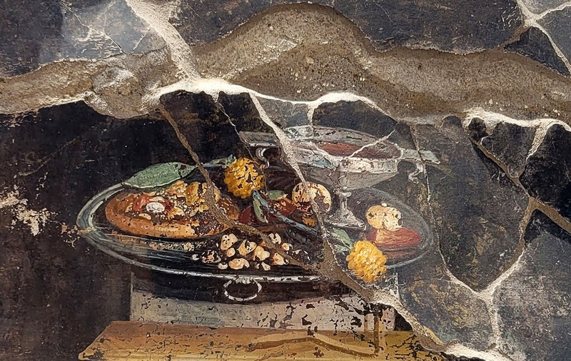 O frescă veche de 2.000 de ani, descoperită în orașul Pompei, pare să ilustreze o pizza antică