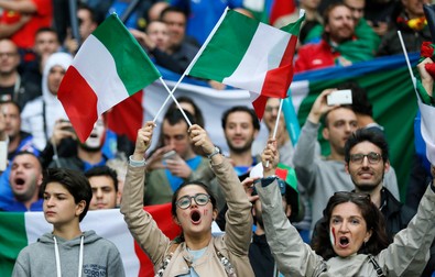 epa05362516 Supporters of Italy cheer prior to the UEFA EURO 2016 group E preliminary round match between Belgium and Italy at Stade de Lyon in Lyon, France, 13 June 2016. (RESTRICTIONS APPLY: For editorial news reporting purposes only. Not used for commercial or marketing purposes without prior written approval of UEFA. Images must appear as still images and must not emulate match action video footage. Photographs published in online publications (whether via the Internet or otherwise) shall have an interval of at least 20 seconds between the posting.) EPA/SERGEY DOLZHENKO EDITORIAL USE ONLY