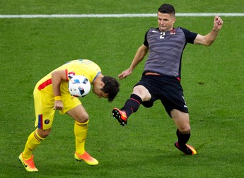 epa05377851 Alexandru Matel (L) of Romania in action against Andi Lila (R) of Albania during the UEFA EURO 2016 group A preliminary round match between Romania and Albania at Stade de Lyon in Lyon, France, 19 June 2016. (RESTRICTIONS APPLY: For editorial news reporting purposes only. Not used for commercial or marketing purposes without prior written approval of UEFA. Images must appear as still images and must not emulate match action video footage. Photographs published in online publications (whether via the Internet or otherwise) shall have an interval of at least 20 seconds between the posting.) EPA/MAST IRHAM EDITORIAL USE ONLY