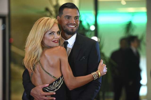 Manchester's United goalkeeper, Argentinian Sergio Romero, poses with his wife on a red carpet during Argentine football star Lionel Messi and Antonella Roccuzzos wedding in Rosario, Santa Fe province, Argentina on June 30, 2017. Footballers and celebrities including pop singer Shakira gathered Friday for the "wedding of the century" in Lionel Messi's Argentine hometown as the Barcelona superstar prepared to marry his childhood sweetheart Antonella Roccuzzo. / AFP PHOTO / EITAN ABRAMOVICH