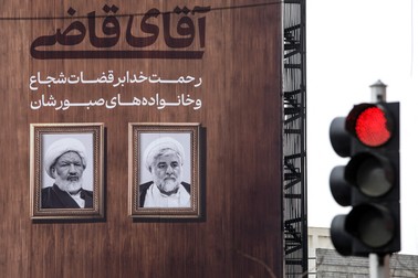 A banner bearing pictures of slain judges Ali Razini (R) and Mohammad Moghiseh is hung on the wall of a building in central Tehran's Valiasr square on January 19, 2025. The two judges were killed in a shooting attack on January 18 at the supreme court building in Tehran, Iranian state media reported.,Image: 955297416, License: Rights-managed, Restrictions: , Model Release: no