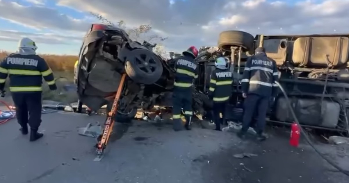 Pompieri care intervin la locul unui accident între o mașină și un TIR