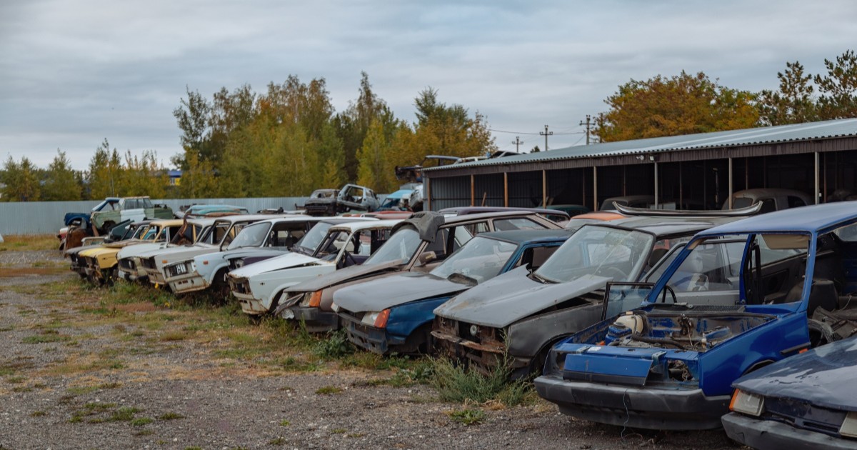Mai multe mașini vechi, accidentate, avariate sau aproape dezmembrate, într-un parc auto