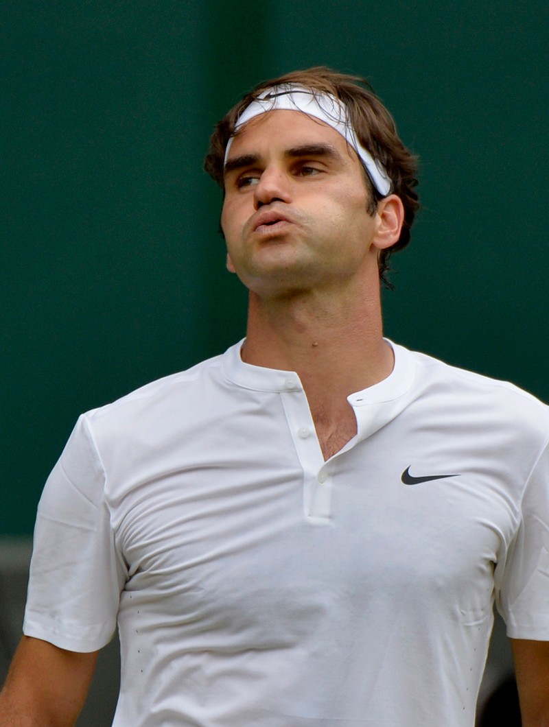 epa04844135 Roger Federer of Switzerland in action against Novak Djokovic of Serbia during their final match for the Wimbledon Championships at the All England Lawn Tennis Club, in London, Britain, 12 July 2015. EPA/ANDY RAIN EDITORIAL USE ONLY/NO COMMERCIAL SALES