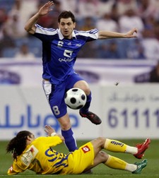 Al Hilal's Romanian player Mirel Radoi fights for the ball against Al-Nasr Brazilian player Alton Gomes, below, during the Crow Prince Sultan bin Abdel Aziz Cup at King Fahd stadium in Riyadh, Saudi Arabia, Monday, Feb. 23, 2009. (AP Photo/Hassan Ammar)