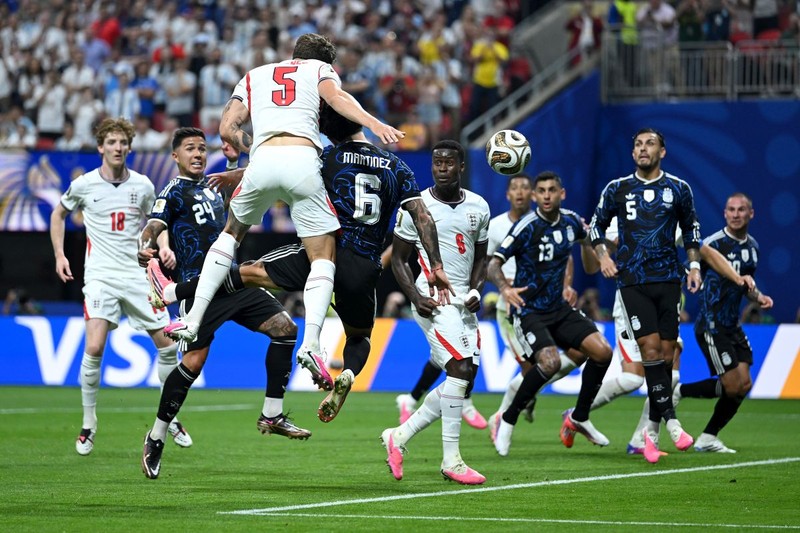 ATLANTA, GEORGIA - JULY 15: John Stones #5 of England competes for a header against Lisandro Martinez #6 of Argentina during the FIFA World Cup 2026 Semi Final match between England and Argentina at Atlanta Stadium on July 15, 2026 in Atlanta, Georgia. (Photo by Shaun Botterill/Getty Images)