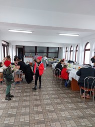 Familii de ucraineni cu copii la masă, la Protoieria Niculițel, care și-a deschis porțile pentru refugiați