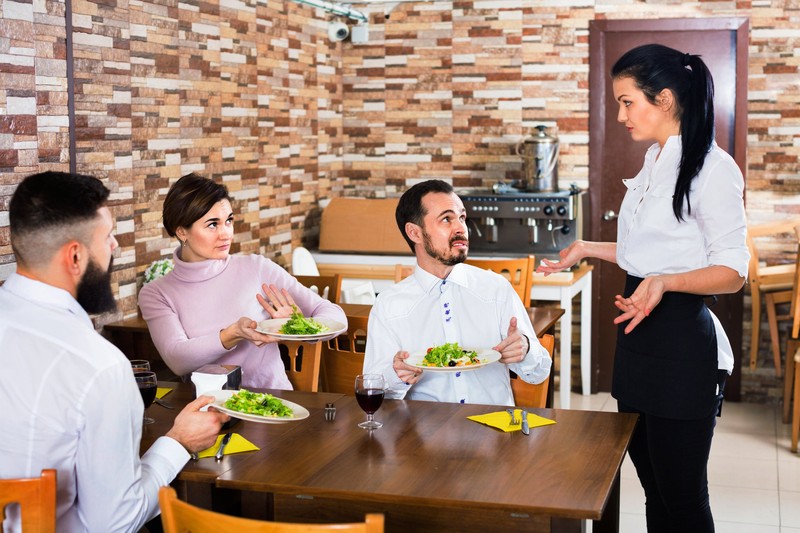 Unpleased client talking with manager in restaurant
