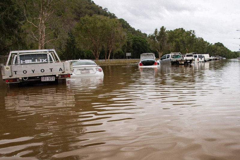 This picture shows cars amid floodwaters at Cairns Airport in Cairns on December 18, 2023. Flash floods swamped northeastern Australia on December 18, with raging waters severing roads and flushing crocodiles into towns.,Image: 830467964, License: Rights-managed, Restrictions: , Model Release: no