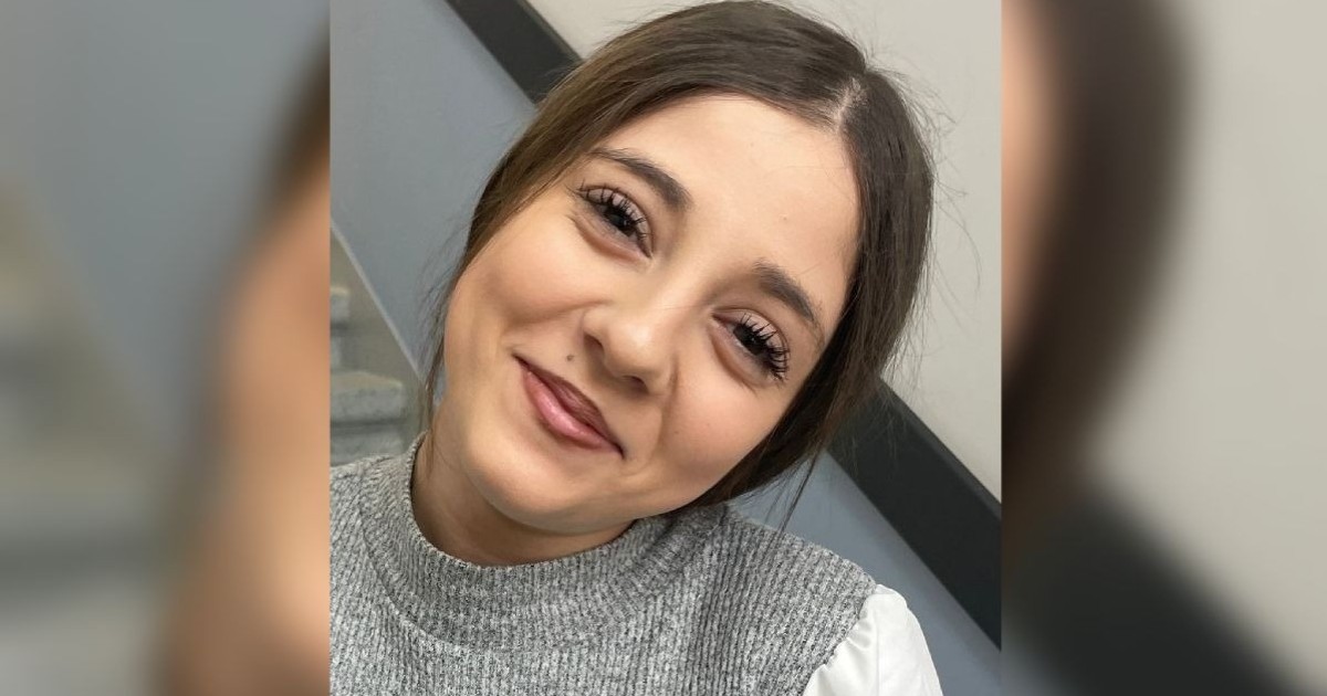 Burlacu Daria Yasmina Ștefania într-o bluză gri, în timp ce zâmbește.