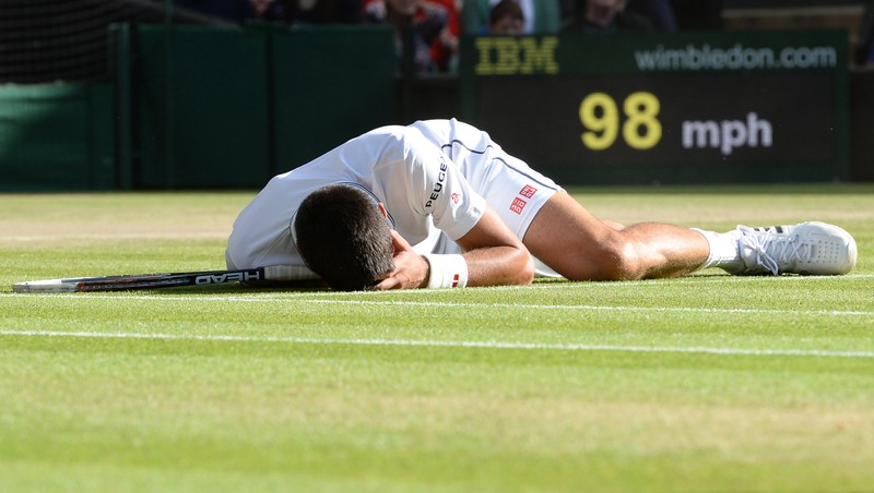 epa04302773 Novak Djokovic of Serbia returns to Roger Federer of Switzerland in the men's singles final of the Wimbledon Championships at the All England Lawn Tennis Club, in London, Britain, 06 July 2014. EPA/ANDY RAIN EPA/ANDY RAIN EPA/ANDY RAIN