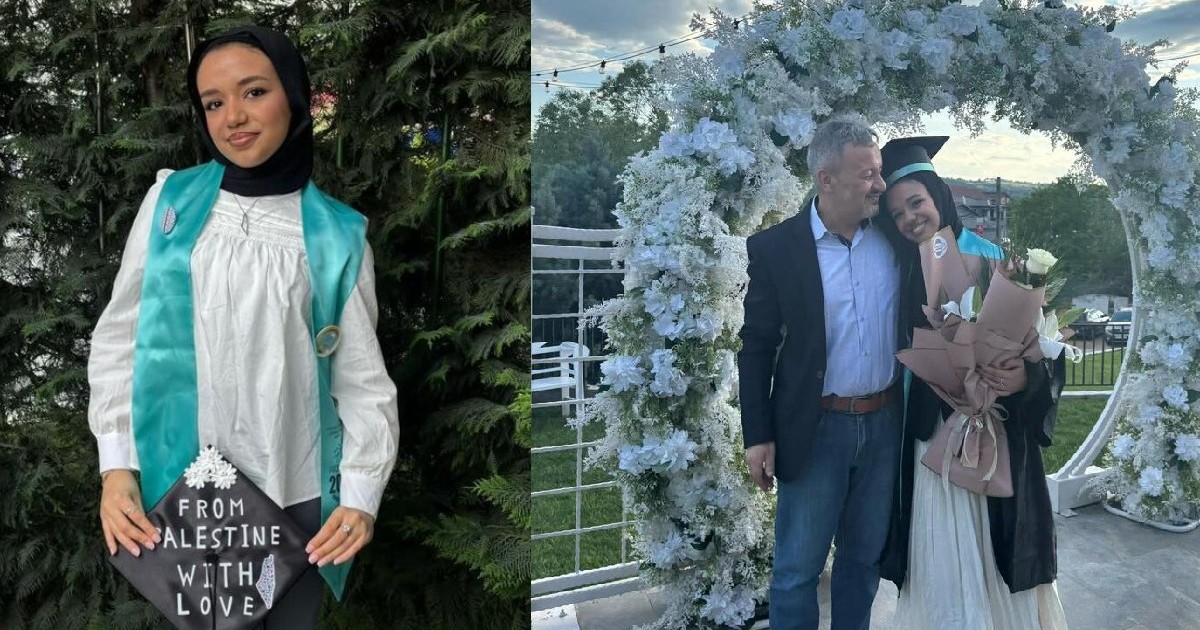 O tânără ține în mână o tocă neagră pe care scrie „From Palestine with Love”, poartă o bluzp albă și pantaloni gri, la gât are o eșarfă verde, iar pe cap poartă un batic negru