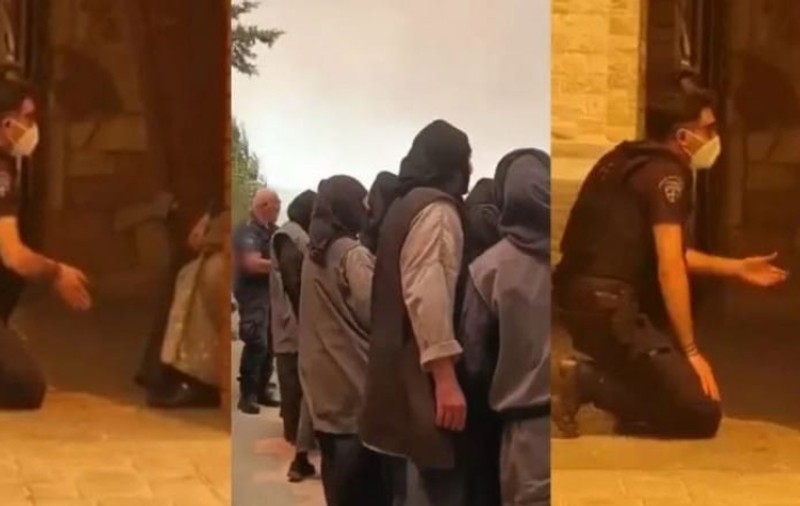 Imagini surprinse la o mănăstire din Grecia. Un polițist stă în genunchi în fața călugărițelor care refuză să evacueze locul aflat în calea incendiilor
