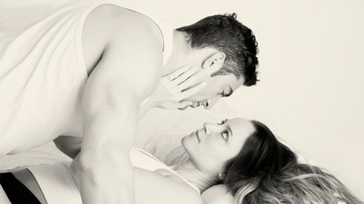 46074598 - young couple in bed, black and white