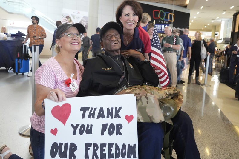 World War II veteran Louis Brown, center, poses for photos with Lorna Paden, left, and Kerre Randel before heading to board a flight with other veterans at Dallas Fort Worth International Airport in Dallas Friday, May 31, 2024. A group of World War II veterans are being flown from Texas to France where they will take part in ceremonies marking the 80th anniversary of D-Day.,Image: 878032137, License: Rights-managed, Restrictions: This content is intended for editorial use only. For other uses, additional clearances may be required., Model Release: no, Pictured: Fred Taylor