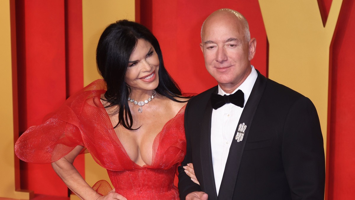 Lauren Sánchez, într-o rochie roșie decoltată, alături de miliardarul Jeff Bezos participă la Vanity Fair Oscar Party 2024 . FOTO: Hepta