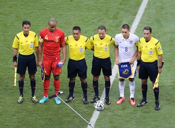 epa04294851 Algerian referee Djamel Haimoudi (3-R) his compatriot assistant referees Redouane Achik (R) and Abdelhak Etchiali (L), fourth official Norbert Hauata of Tahiti (3-L), and skippers Vincent Kompany of Belgium (2-L) and Clint Dempsey of USA (2-R) pose prior the FIFA World Cup 2014 round of 16 match between Belgium and the USA at the Arena Fonte Nova in Salvador, Brazil, 01 July 2014. (RESTRICTIONS APPLY: Editorial Use Only, not used in association with any commercial entity - Images must not be used in any form of alert service or push service of any kind including via mobile alert services, downloads to mobile devices or MMS messaging - Images must appear as still images and must not emulate match action video footage - No alteration is made to, and no text or image is superimposed over, any published image which: (a) intentionally obscures or removes a sponsor identification image; or (b) adds or overlays the commercial identification of any third party which is not officially associated with the FIFA World Cup) EPA/ALI HAIDER EDITORIAL USE ONLY