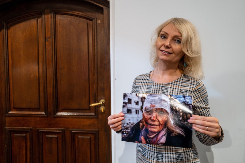 WARSAW, POLAND - NOVEMBER 09: Ukrainian teacher Olena Kurilo, who has become the symbol of the Russia-Ukraine war with her iconic photo -- her head wrapped in a bandage, her face caked with blood after the airstrike -- that Anadolu Agency photojournalist Wolfgang Schwan took on Feb. 24, poses with her iconic photo during an exclusive interview for Anadolu Agency in Warsaw, Poland on November 09, 2022. In the city of Chuhuiv in the Kharkiv Oblast of eastern Ukraine, Anadolu Agency photojournalist Wolfgang Schwan took shots of civilian casualties by Russian missile strikes on Feb. 24 and among his photos, a picture of teacher Olena Kurilo has become one of the most striking images of the conflict. Kurilo and Schwan come together in Warsaw after 9 months. Wolfgang Schwan / Anadolu Agency/ABACAPRESS.COM