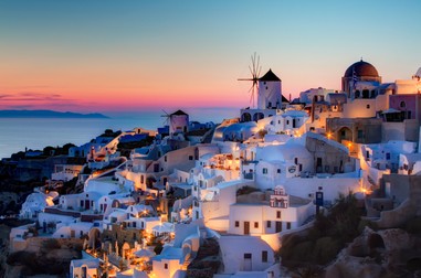 Sunset in Oia, Santorini. Here is my version of the sunset shot in Oia. This is a blend of 3 shots, 1.3 to 20 seconds, processed as follows: 1) Reduce noice on all 3 raws. 2) Create HRD in Photomatix 3) Blend using Exposure Fusion, sliders set to produce the most natural looking image while still showing some detail in the very dark areas. 4) PS smart sharpen. 5) PS burn the bottom 6) Nik Brilliance and warming 7) Nik Indian summer to warm th elights, masked to not affect the rest. 8) Nik sunlight, brushed over the buildings to add more light 9) Nik Glamour Glow to remove detail in the dark areas. 10) Detailed curves lightening pn windmills. 11) Dodge buildings that were too dark.