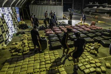 Colombian navy men and women arrange marihuana packages after a boat was seized with approximately 2.5 tons of marihuana near the Port of Buenaventura, Valle del Cauca department, Colombia, on March 10, 2024.,Image: 856259132, License: Rights-managed, Restrictions: , Model Release: no