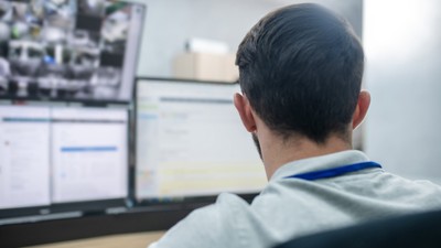 Man with his back to camera working at computer
