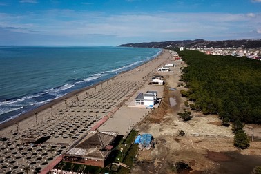 A picture taken on February 22, 2018 shows a panoramic view of the Spille beach covered in reed-knitted umbrellas. Some 58 hectares of pine forest in this pristine and coveted area, have been embezzled through fraud and registered to unwitting villagers as farmland, only to be transferred later to property developers. The prosecution office has started a wide investigation into the case involving officials in the office of registration of immovable property, public notaries and developers.,Image: 366969936, License: Rights-managed, Restrictions: TO GO WITH AFP STORY BY BRISEIDA MEMA, Model Release: no