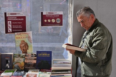 December 16, 2024, Tijuana, Baja California, Mexico: Juan Ramon Sotomayor took an interest in the personal improvement book section at the Occasional Used Book Store "Antiguo" Fair at a downtown Revolution Avenue bus station of the Tijuana Comprehensive Transportation System (STT) in Tijuana, Mexico on Monday, December 16, 2024. Rene Castillo from the Graphographer: books &amp; coffee shop and organizer of the book fair highlighted that the fair was taking and intervening in public spaces like the not so used bus station, to bring books closer to people and ferment a culture of book reading and appreciation, which was contemplated in collaboration with the local Tijuana government and the Municipal Institute of Art and Culture,Image: 947838184, License: Rights-managed, Restrictions: , Model Release: no