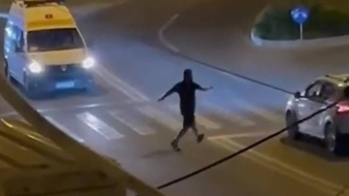 Bărbatul din Galați în timp ce stă pe trecerea de pietoni și oprește mașinile ca mai apoi să le tragă portiera sau să le lovească cu picioarele