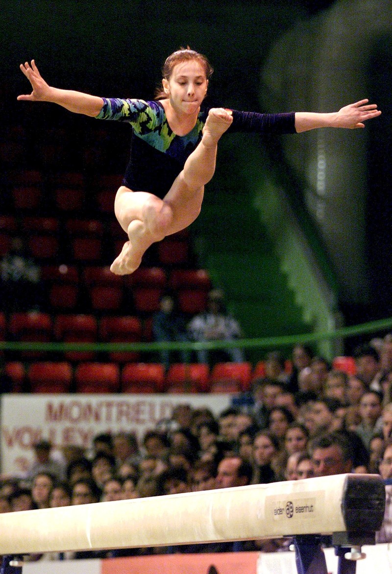 MON105-20000318-MONTREUX, SWITZERLAND: Romanian gymnast Andreea Raducan performs on the beam during the finals of the Gymnastics World Cup in Montreux, Switzerland, on Saturday, 18 March 2000. Raducan won the beam event. (ELECTRONIC IMAGE) EPA PHOTO KEYSTONE/FABRICE COFFRINI/MAI