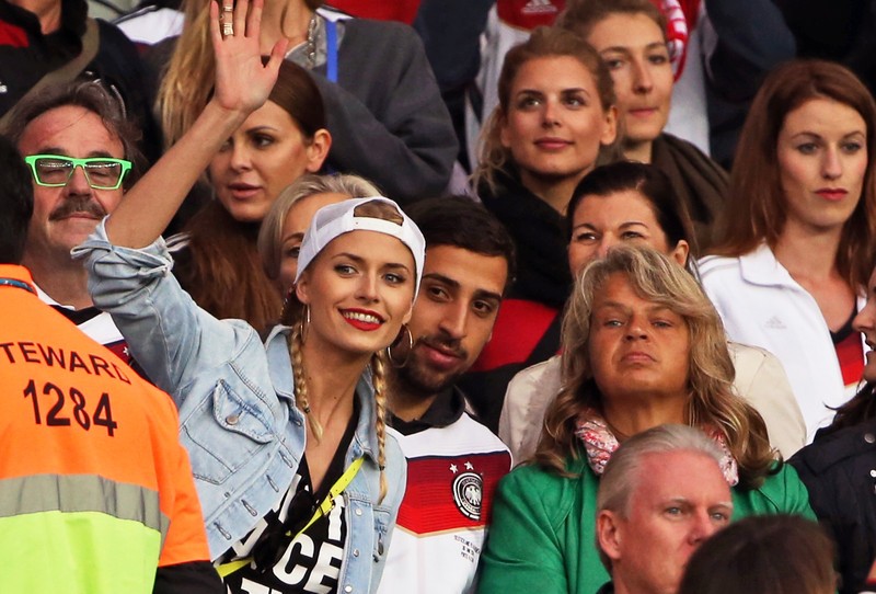 epa04292528 Germany's Sami Khedira's girlfriend Lena Gercke, his brother Denny Khedira, and his mother Doris cheer on the stands during the FIFA World Cup 2014 round of 16 match between Germany and Algeria at the Estadio Beira-Rio in Porto Alegre, Brazil, 30 June 2014. (RESTRICTIONS APPLY: Editorial Use Only, not used in association with any commercial entity - Images must not be used in any form of alert service or push service of any kind including via mobile alert services, downloads to mobile devices or MMS messaging - Images must appear as still images and must not emulate match action video footage - No alteration is made to, and no text or image is superimposed over, any published image which: (a) intentionally obscures or removes a sponsor identification image; or (b) adds or overlays the commercial identification of any third party which is not officially associated with the FIFA World Cup) EPA/OLIVER WEIKEN EDITORIAL USE ONLY