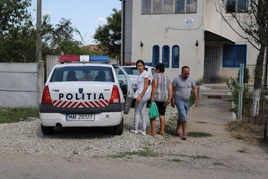 Fata este urcată în mașina poliției și dusă să la locul agresiunii, pentru reconstituire. De la Craiova a fost trimis un fotograf, pentru recoltarea probelor. FOTO: Sorin Cioponea (Dioști)