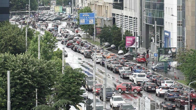 Zeci de autoturisme așteaptă la semafor intrarea în Piața Victoriei de pe strada Buzești în timpul orelor de vârf ale traficului auto în București. Foto: Hepta