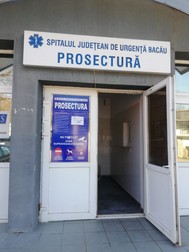 Numele firmei și numărul de telefon sunt trecute pe un afiș, la intrarea în morgă