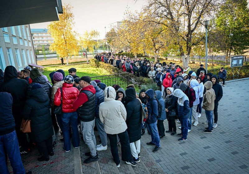 Residents of Transnistria region wait in line to vote during Moldova's second round presidential election, at a polling station in Costesti, northern Moldova on November 3, 2024. Moldovans vote in a tense presidential election runoff that could decide whether the ex-Soviet country continues on a pro-European path or tilts back toward Russia's influence.,Image: 929951244, License: Rights-managed, Restrictions: , Model Release: no