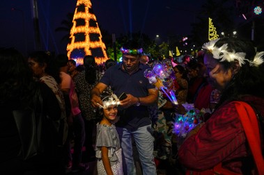 People buy decorated headgear as they celebrate New Year's eve at a promenade in Mumbai, India, Sunday, Dec. 31, 2023.,Image: 833443685, License: Rights-managed, Restrictions: This content is intended for editorial use only. For other uses, additional clearances may be required., Model Release: no