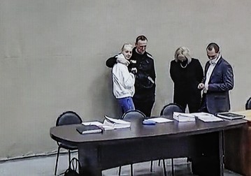 epa09757936 Russian opposition leader and activist Alexei Navalny and his wife Yulia Navalnaya (L) seen on a monitor screen during an offsite court session in the penal colony N2 (IK-2) in Pokrov, Vladimir region, Russia, 15 February 2022. At an offsite court hearing in the penal colony N2 (IK-2), the Lefortovsky District Court of Moscow is conducting a trial of opposition leader Alexei Navalny, who has been imprisoned here for almost a year. An opposition blogger is being tried on charges of contempt of court and fraud. The founder of the Anti-Corruption Foundation, Alexei Navalny, was poisoned in the summer of 2020 and taken to Berlin for treatment, from where he flew to Moscow in January 2021. Immediately upon his return to Russia, he was detained and arrested, the court replaced his suspended sentence with a real one in the Yves Rocher case. Since March 2021, he has been in a colony in the city of Pokrov, Vladimir Region, he has been registered as prone to extremism. EPA-EFE/YURI KOCHETKOV