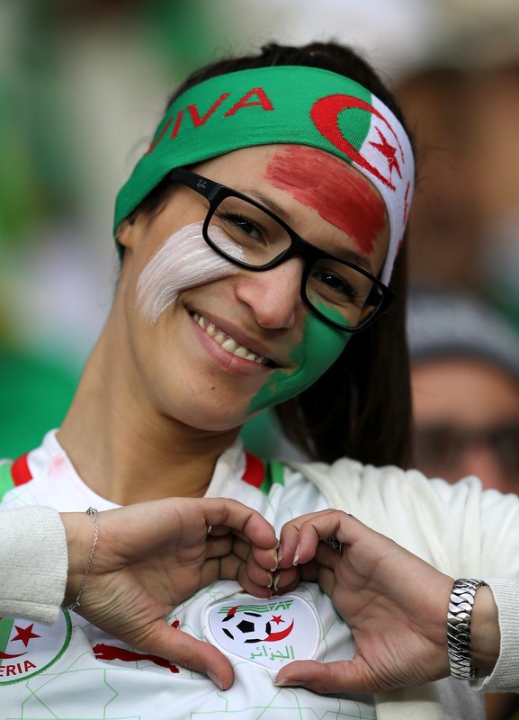 epa04292405 A supporter of Algeria before the FIFA World Cup 2014 round of 16 match between Germany and Algeria at the Estadio Beira-Rio in Porto Alegre, Brazil, 30 June 2014. (RESTRICTIONS APPLY: Editorial Use Only, not used in association with any commercial entity - Images must not be used in any form of alert service or push service of any kind including via mobile alert services, downloads to mobile devices or MMS messaging - Images must appear as still images and must not emulate match action video footage - No alteration is made to, and no text or image is superimposed over, any published image which: (a) intentionally obscures or removes a sponsor identification image; or (b) adds or overlays the commercial identification of any third party which is not officially associated with the FIFA World Cup) EPA/MOHAMED MESSARA EDITORIAL USE ONLY