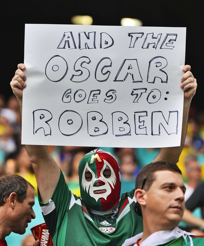 epa04301480 A supporter of Mexico shows a placard cheer before the FIFA World Cup 2014 quarter final match between the Netherlands and Costa Rica at the Arena Fonte Nova in Salvador, Brazil, 05 July 2014. (RESTRICTIONS APPLY: Editorial Use Only, not used in association with any commercial entity - Images must not be used in any form of alert service or push service of any kind including via mobile alert services, downloads to mobile devices or MMS messaging - Images must appear as still images and must not emulate match action video footage - No alteration is made to, and no text or image is superimposed over, any published image which: (a) intentionally obscures or removes a sponsor identification image; or (b) adds or overlays the commercial identification of any third party which is not officially associated with the FIFA World Cup) EPA/KOEN VAN WEEL EDITORIAL USE ONLY