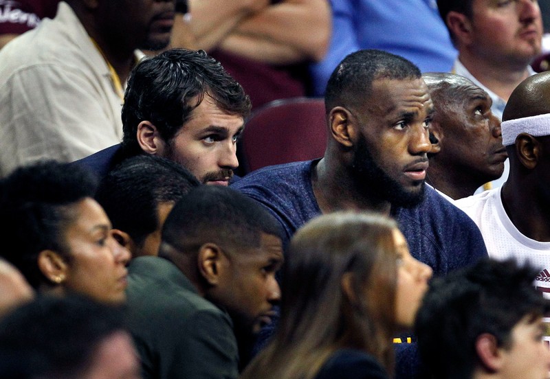 epa04794493 Kevin Love (C-L) and LeBron James (C-R) of the Cleveland Cavaliers watch from the bench against the Golden State Warriors during the second half of Game Four of the NBA Finals at Quicken Loans Arena in Cleveland, Ohio, USA 11 June 2015. EPA/DAVID MAXWELL CORBIS OUT