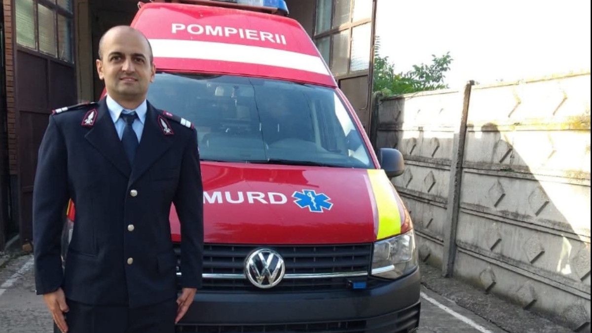 Plutonierul Brîndaș Sergiu lângă o mașină de pompieri SMURD