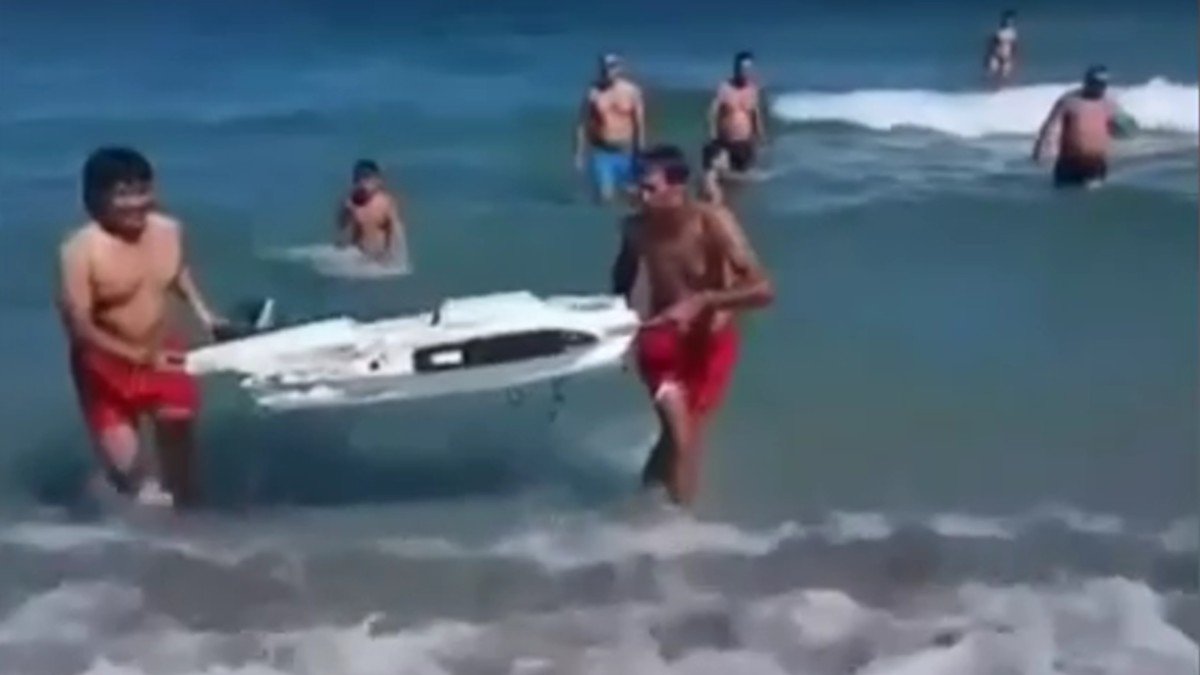 Doi turiști au fost filmați la Năvodari când scoteau o bucată de dronă din mare. Sursă foto: Captură foto /Știrile PRO TV.
