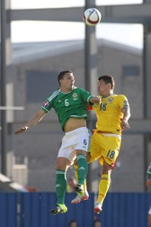 epa04797769 Romania's Andrei Prepeli?and (R) and Northern Ireland's Chris Baird go for a header during the UEFA EURO 2016 qualifying Group F soccer match between Northern Ireland and Romania at Windsor Park in Belfast, Northern Ireland, 13 June 2015. EPA/Paul McErlane