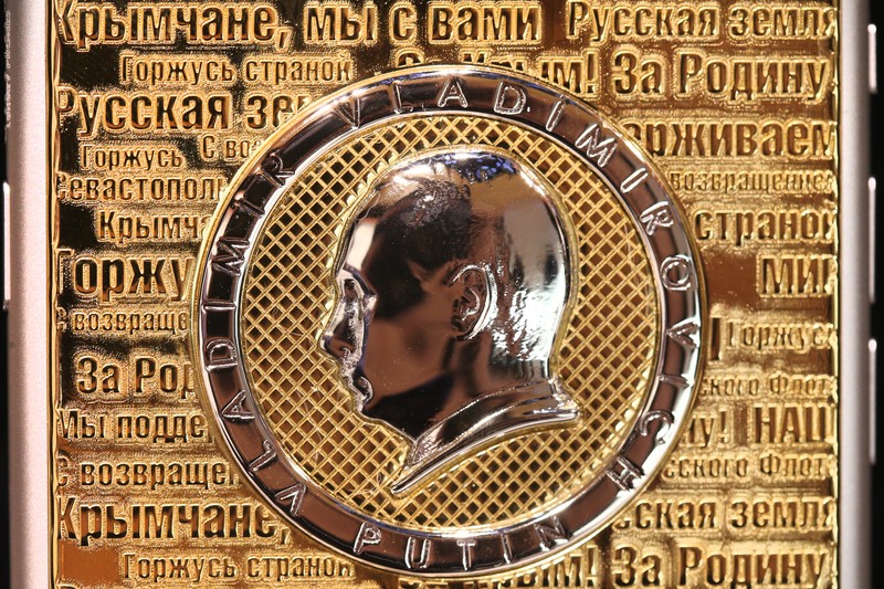 MOSCOW, RUSSIA. MARCH 18, 2016. A Caviar iPhone 6s Supremo Putin Crimea Edition Gold garnished and marketed by Russian-Italian jewellery brand Caviar, commemorates the 2014 reunification of Crimea with Russia. The back of the phone features a likeness of Russian president Vladimir Putin, a map of Crimea, and phrases reflecting reactions of Russian people to the reunification. The price of the phone varies between 199 and 209 thousand Russian roubles. PHOTOGRAPH BY TASS / Barcroft Media UK Office, London. T +44 845 370 2233 W www.barcroftmedia.com USA Office, New York City. T +1 212 796 2458 W www.barcroftusa.com Indian Office, Delhi. T +91 11 4053 2429 W www.barcroftindia.com March , 2016 *** Local Caption *** 02463371