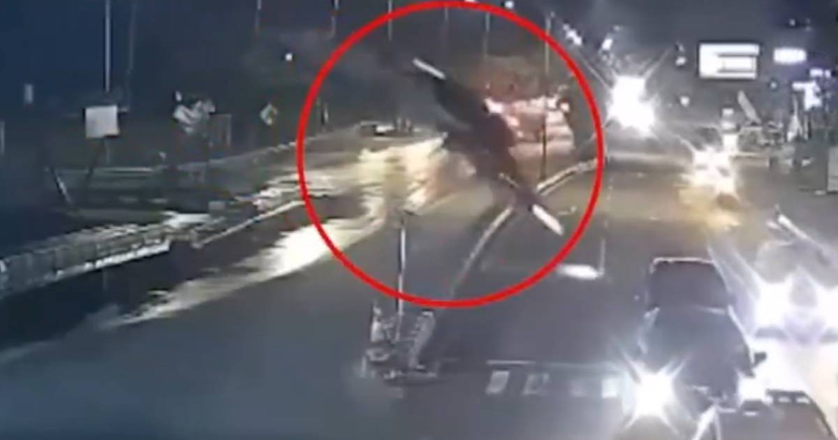 BMW-ul surprins în aer, înainte de a se prăbuși pe o șosea din Indonezia. Mai multe mașini se află pe șosea