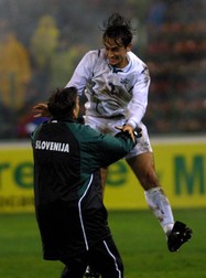 BUC07 - 20011114 - BUCHAREST, ROMANIA : Slovenia's Goran Sankovic (R) celebrates with a member of the Slovenian coaching staff after the end of the second leg World Cup play off game against Romania in Bucharest on Wednesday, 14 November 2001. The final score was 1-1, and the Slovenian team qualified for the World Cup finals 2002 soccer championship. EPA PHOTO EPA/ROBERT GHEMENT/RG/mr