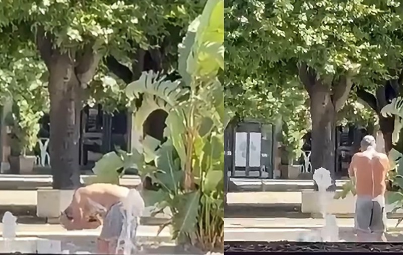 Un bărbat îmbrăcat în pantaloni gri se spală cu săpun într-o fântână arteziană, înconjurată de plante, din Italia.