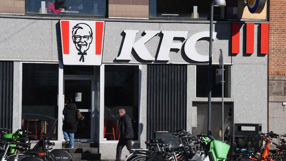 Fațada unui restaurant KFC din Copenhaga în fața căruia sunt parcate foarte multe biciclete.